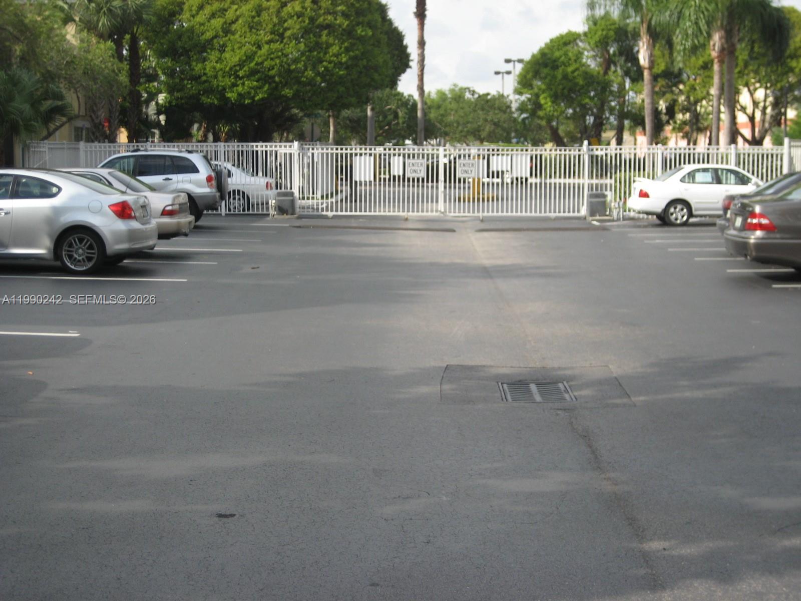 15051 Southwest 103rd Lane, Unit 4103 Miami, FL 33196 - Photo 16 of 19 a view of street with parked cars