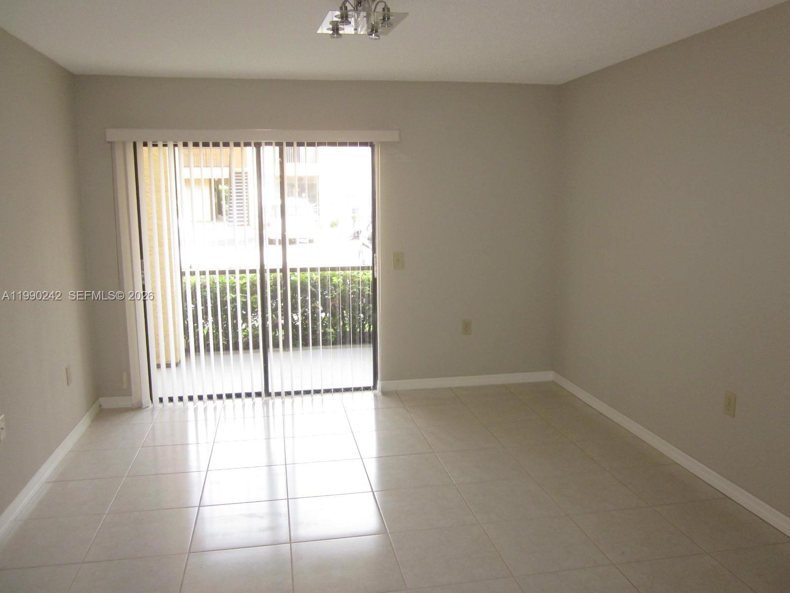 15051 Southwest 103rd Lane, Unit 4103 Miami, FL 33196 - Photo 2 of 19 a view of a window in an empty room
