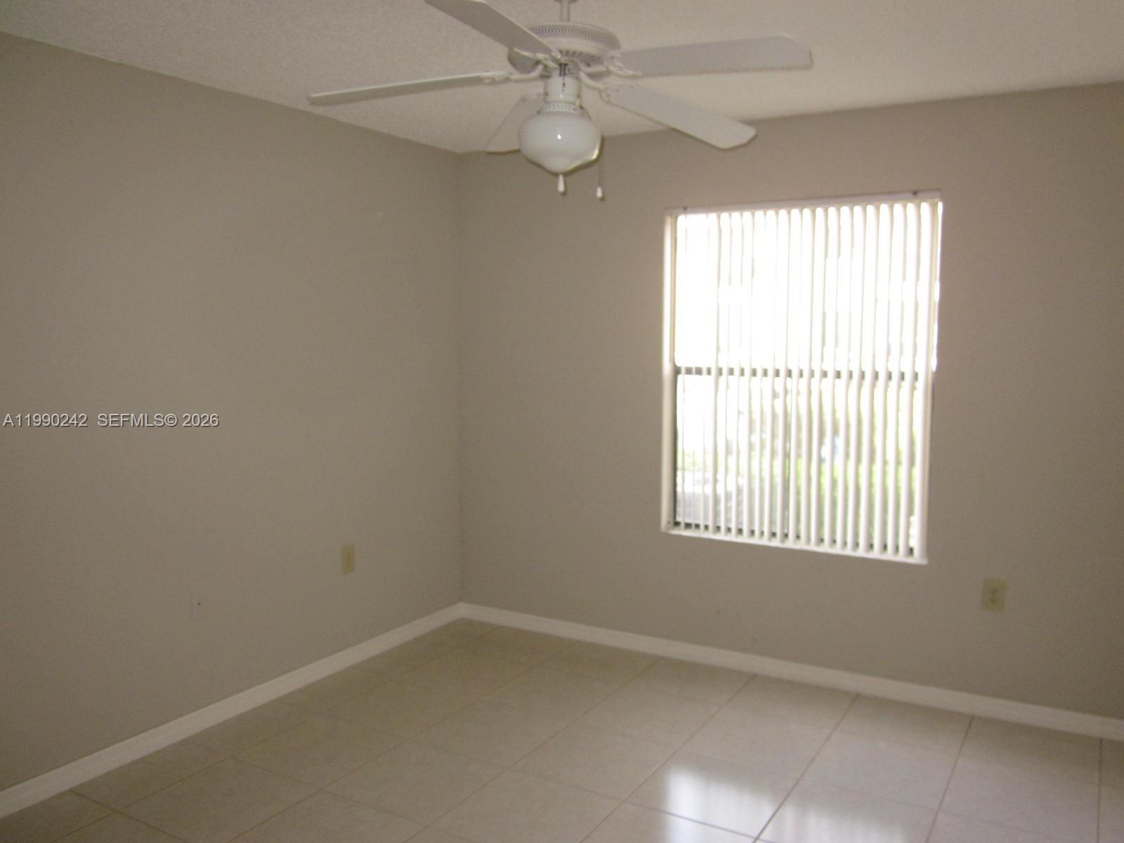 15051 Southwest 103rd Lane, Unit 4103 Miami, FL 33196 - Photo 4 of 19 an empty room with a window