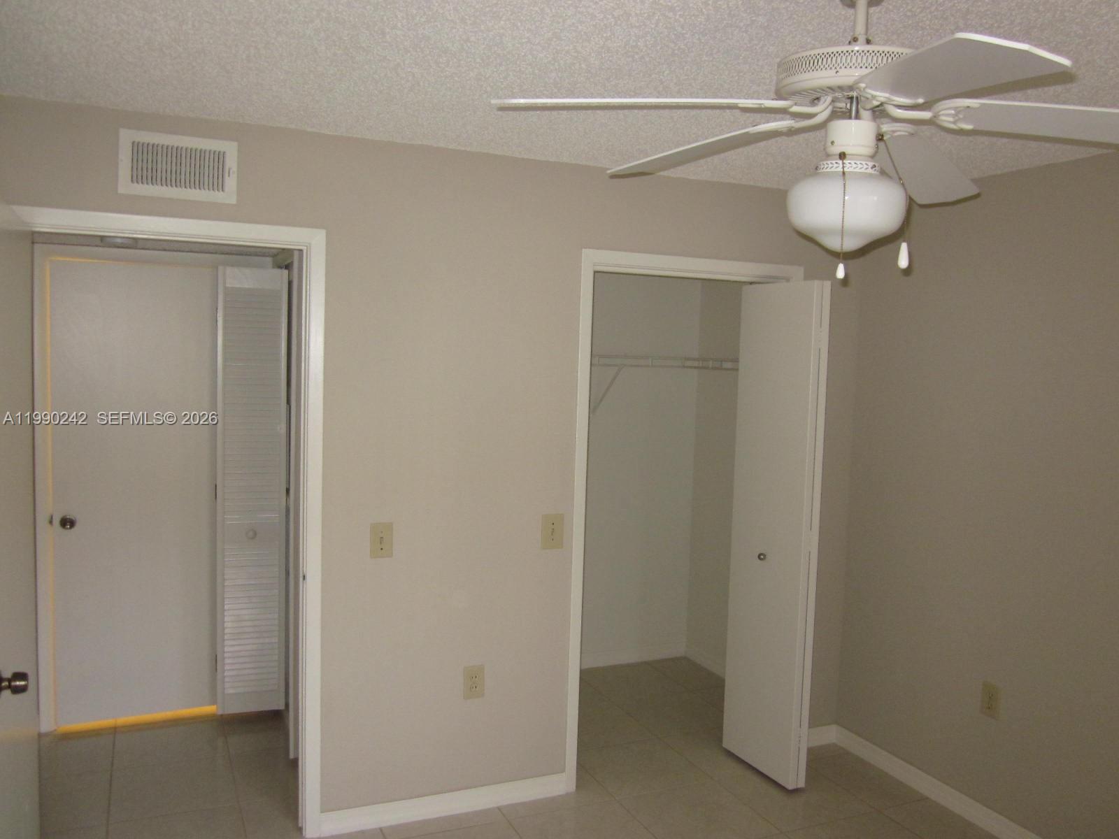 15051 Southwest 103rd Lane, Unit 4103 Miami, FL 33196 - Photo 8 of 19 a view of a room with a hanging light and entryway