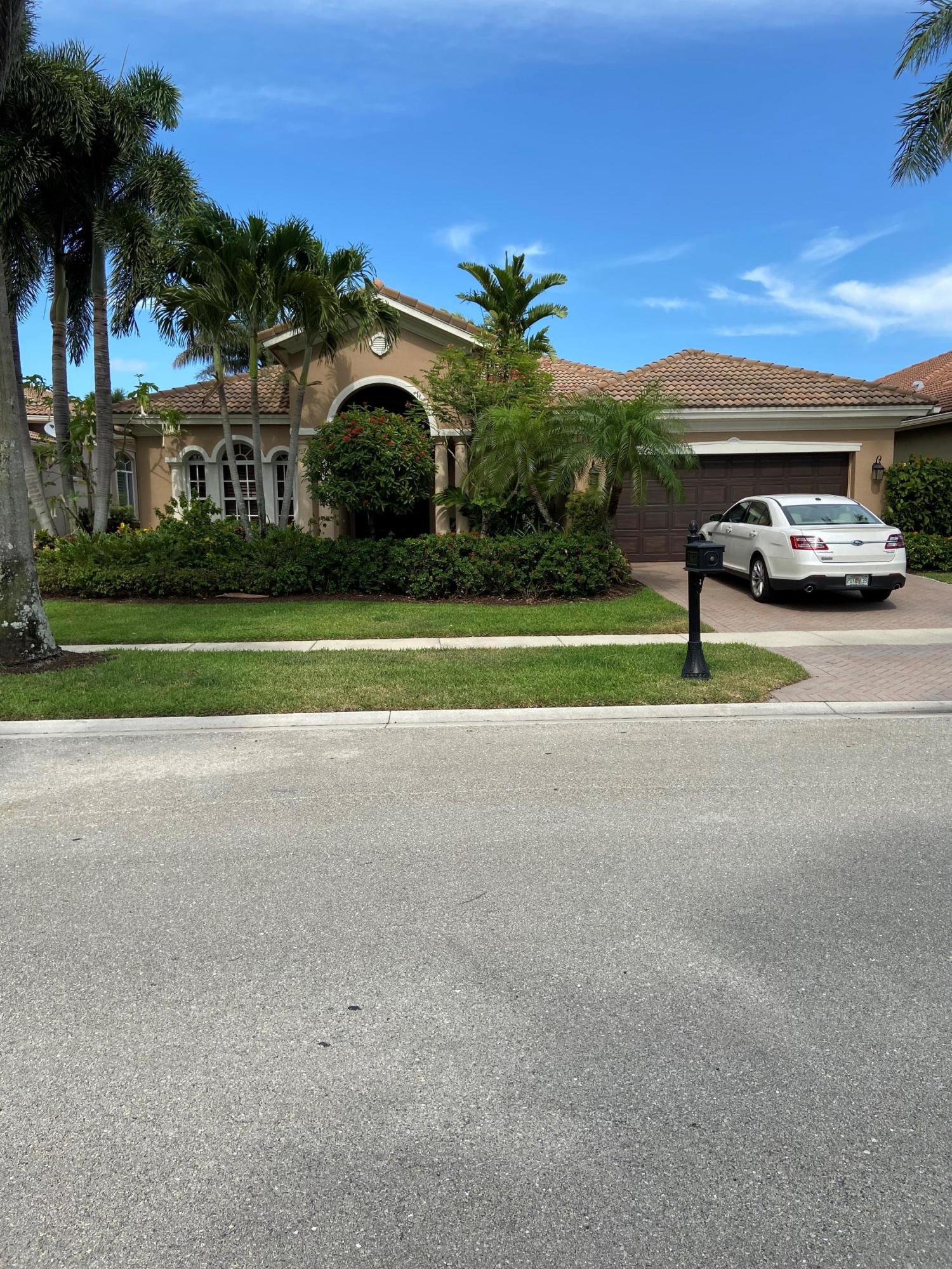 a view of road and car parked in front of house