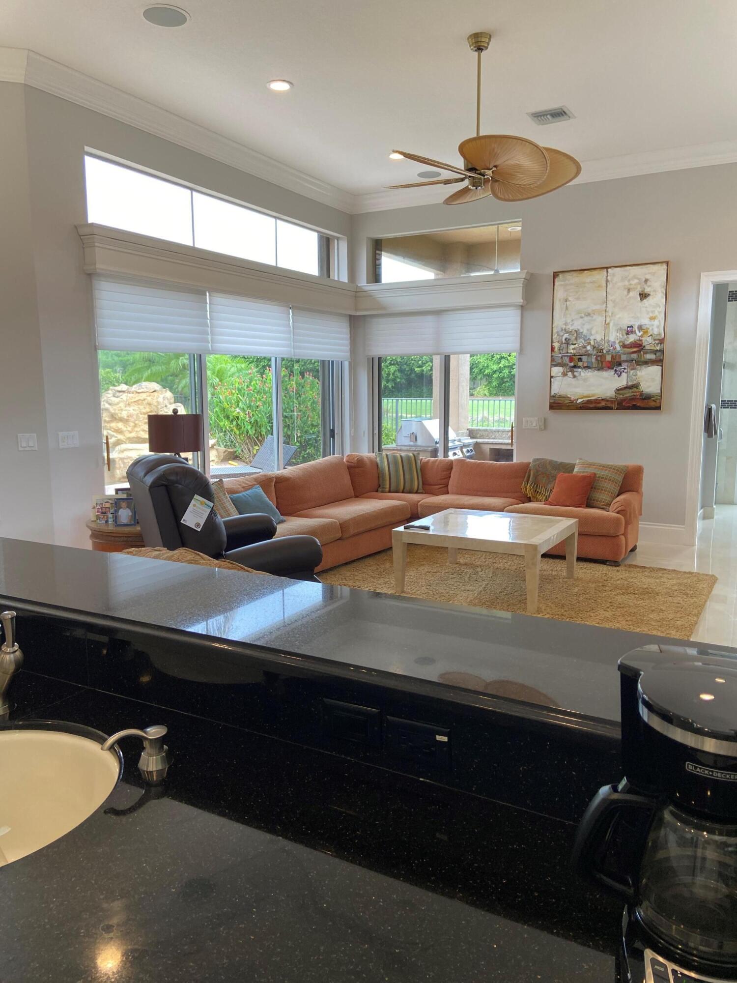 16456 Braeburn Ridge Trail Delray Beach, FL 33446 - Photo 21 of 25 a kitchen with a large window and cabinets