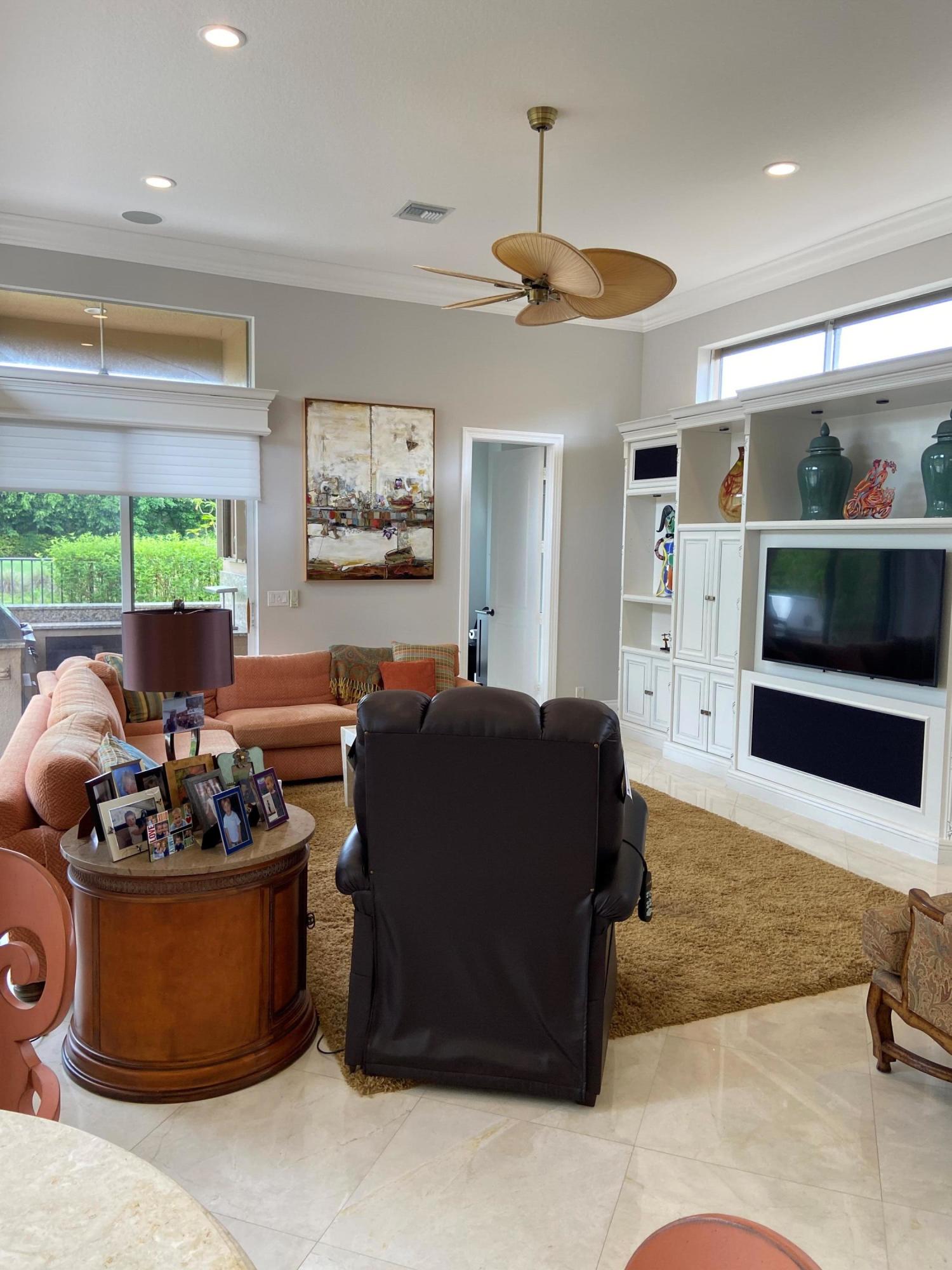16456 Braeburn Ridge Trail Delray Beach, FL 33446 - Photo 23 of 25 a living room with furniture and a flat screen tv