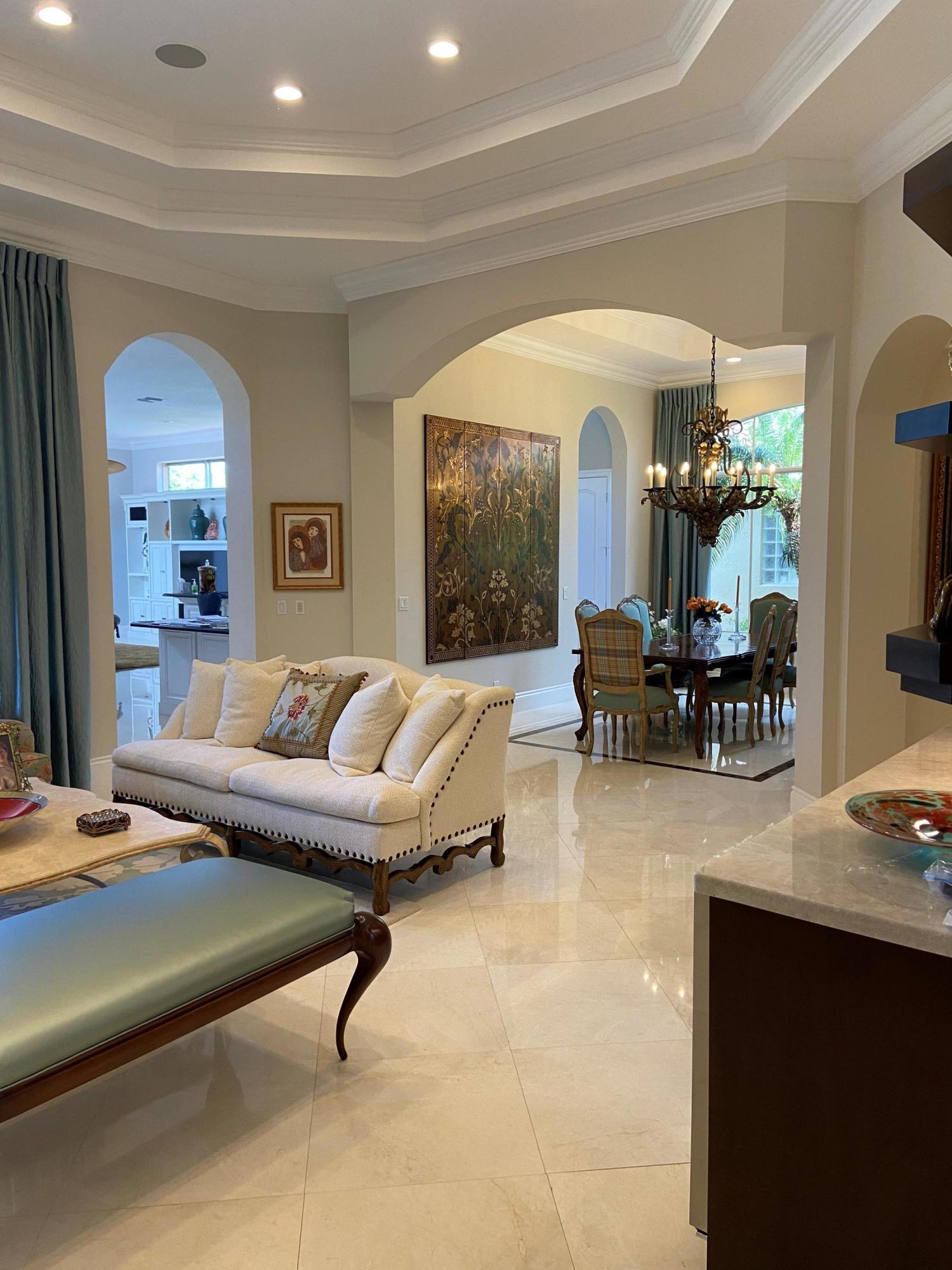 16456 Braeburn Ridge Trail Delray Beach, FL 33446 - Photo 4 of 25 a living room with furniture and a chandelier