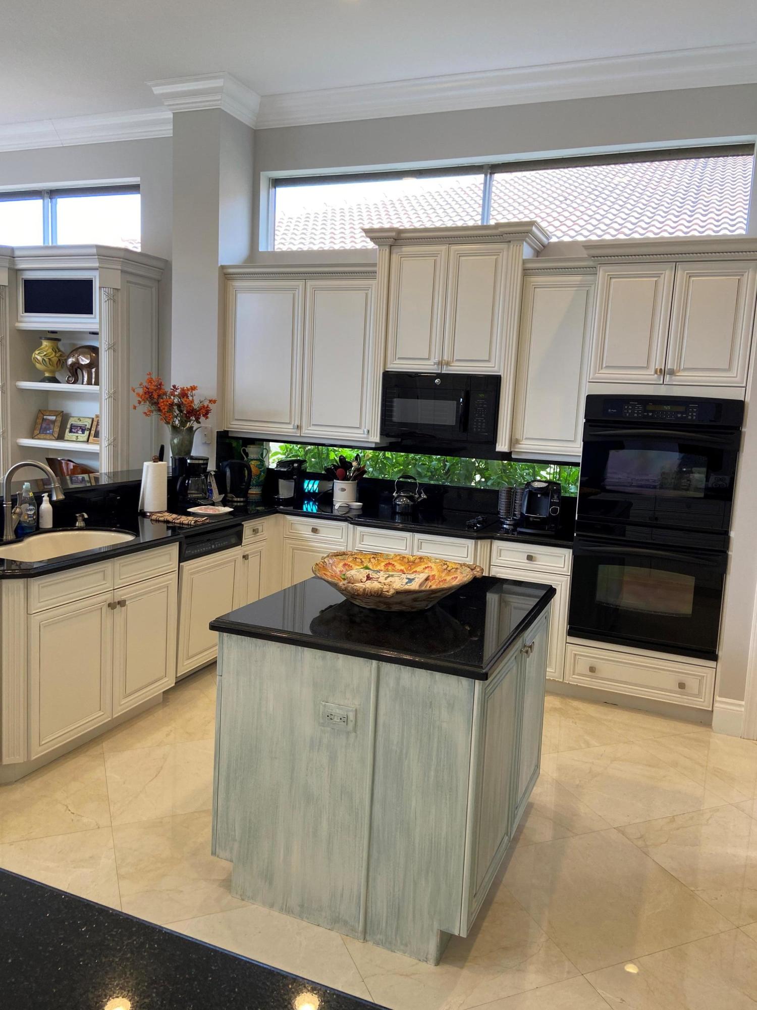 16456 Braeburn Ridge Trail Delray Beach, FL 33446 - Photo 8 of 25 a kitchen with stainless steel appliances granite countertop a stove a sink and a microwave