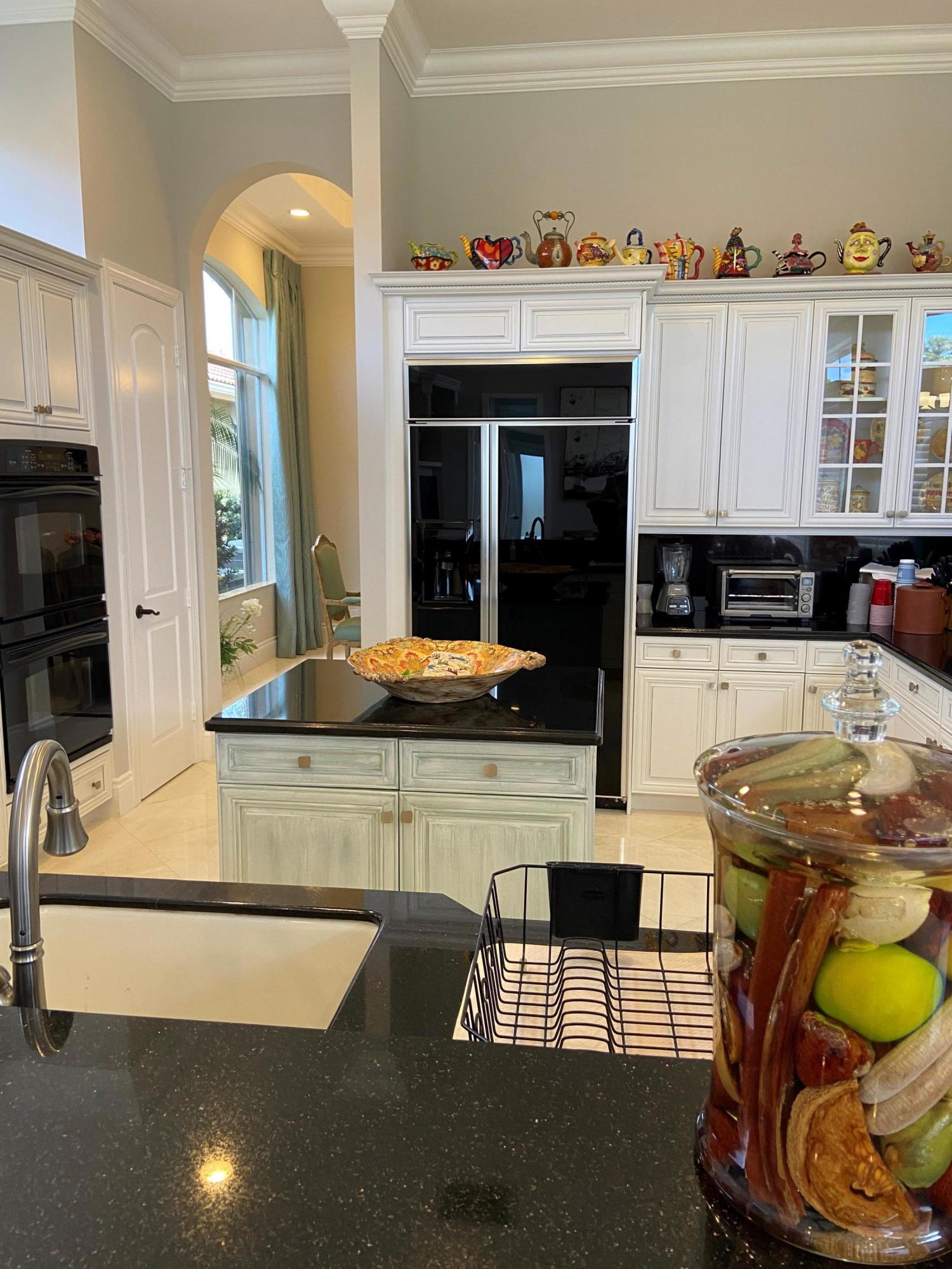 16456 Braeburn Ridge Trail Delray Beach, FL 33446 - Photo 9 of 25 a kitchen with a sink a stove and cabinets
