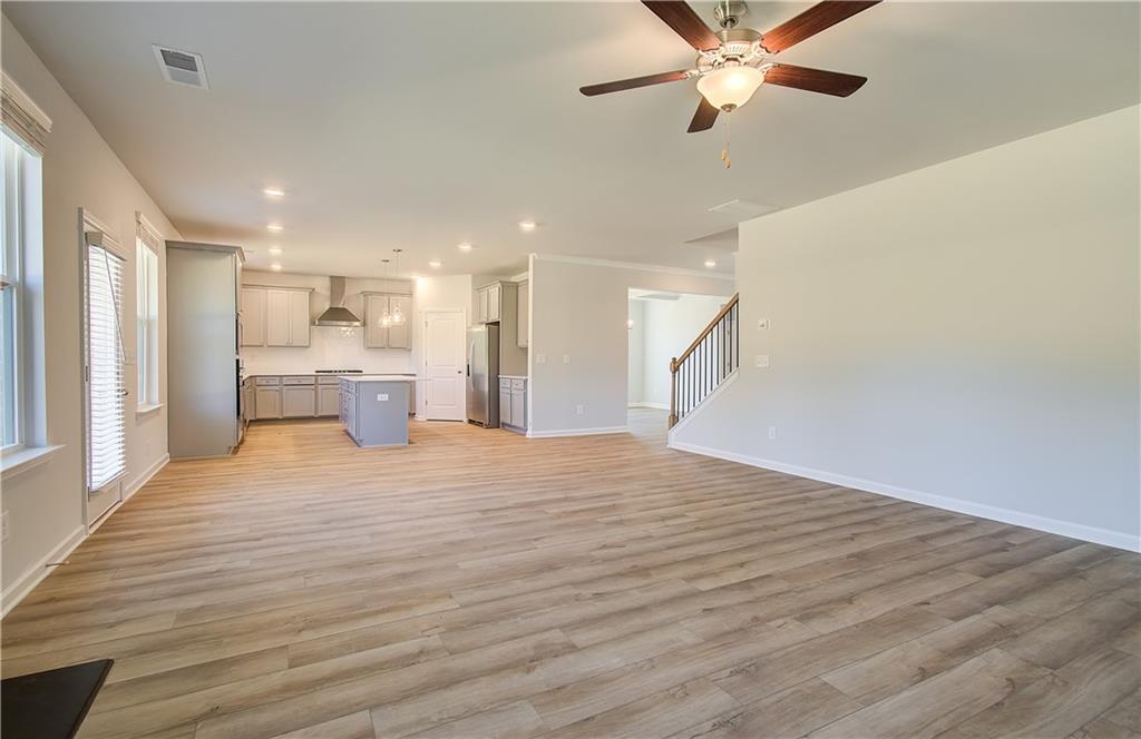 257 Chiswick Loop Stockbridge, GA 30281 - Photo 11 of 32 a view of empty room with wooden floor and fan