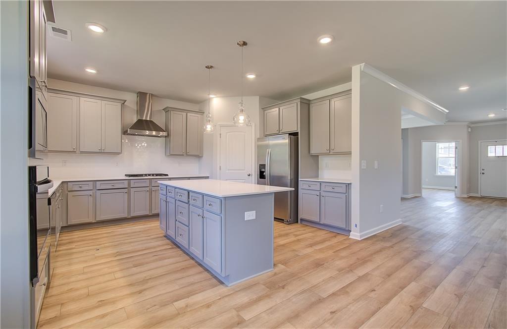 257 Chiswick Loop Stockbridge, GA 30281 - Photo 12 of 32 a large kitchen with stainless steel appliances sink a microwave and cabinets