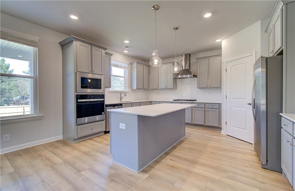 257 Chiswick Loop Stockbridge, GA 30281 - Photo 14 of 32 a large kitchen with stainless steel appliances sink a microwave and cabinets
