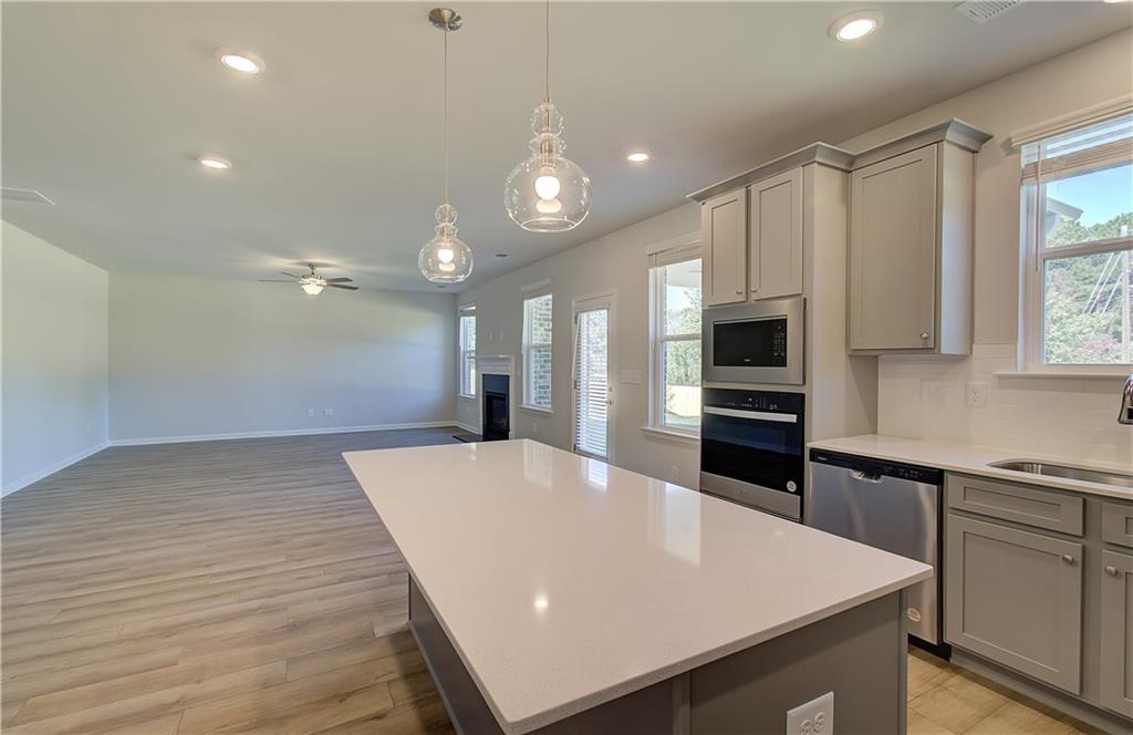 257 Chiswick Loop Stockbridge, GA 30281 - Photo 16 of 32 a large kitchen with kitchen island a sink stainless steel appliances and cabinets