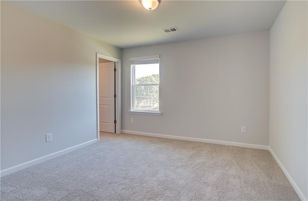 257 Chiswick Loop Stockbridge, GA 30281 - Photo 21 of 32 an empty room with windows