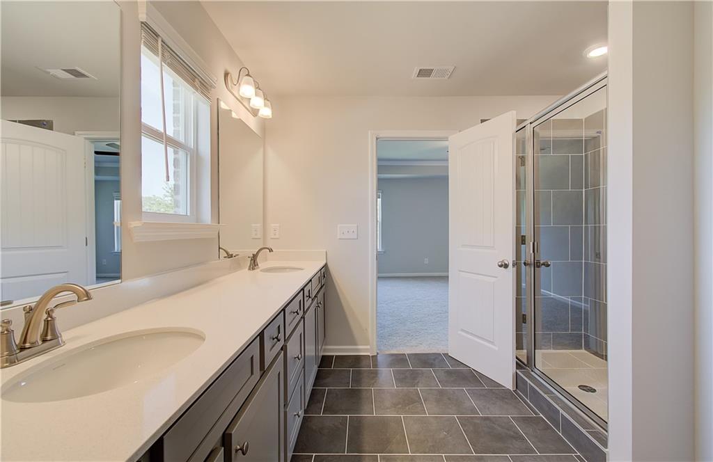 257 Chiswick Loop Stockbridge, GA 30281 - Photo 29 of 32 a bathroom with a sink and a mirror