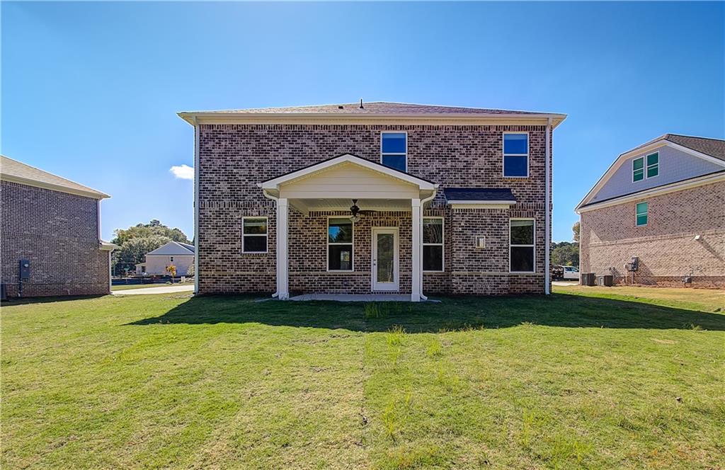 257 Chiswick Loop Stockbridge, GA 30281 - Photo 30 of 32 a front view of a house with a garden