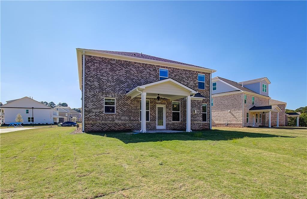 257 Chiswick Loop Stockbridge, GA 30281 - Photo 31 of 32 a front view of a house with a yard