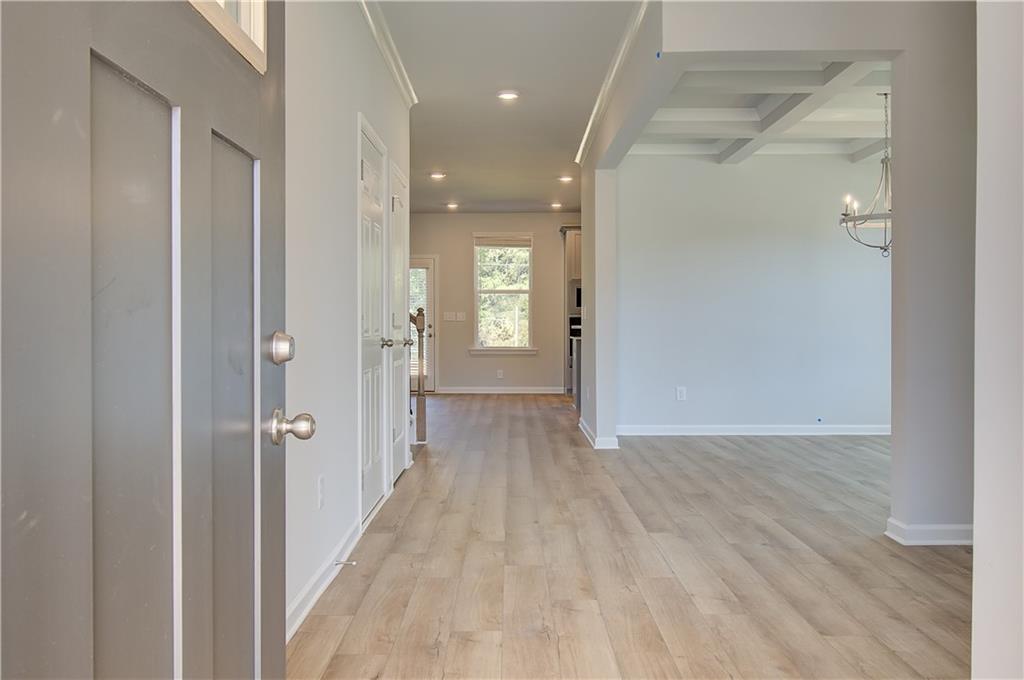 257 Chiswick Loop Stockbridge, GA 30281 - Photo 4 of 32 a view of a hallway with wooden floor and a bathroom