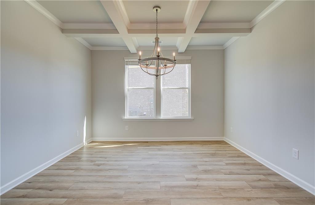 257 Chiswick Loop Stockbridge, GA 30281 - Photo 6 of 32 a view of empty room with wooden floor and fan