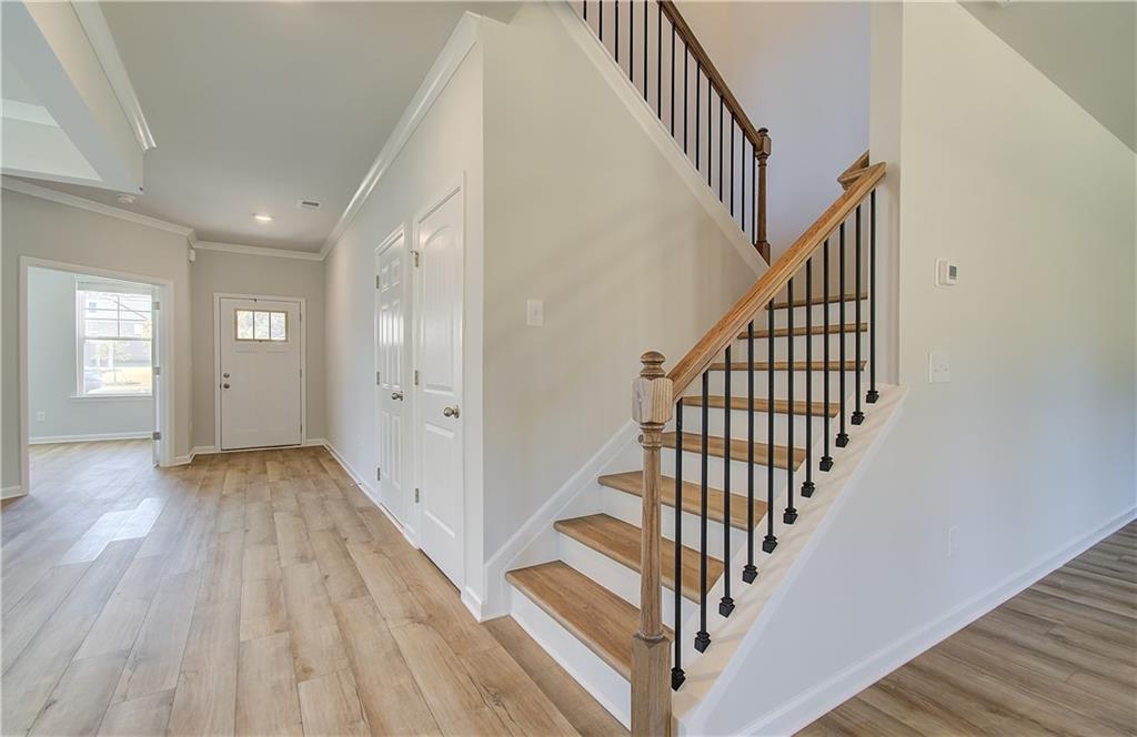257 Chiswick Loop Stockbridge, GA 30281 - Photo 7 of 32 a view of staircase with wooden floor and white walls