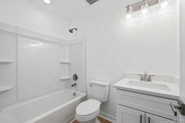 a bathroom with a sink toilet and bathtub