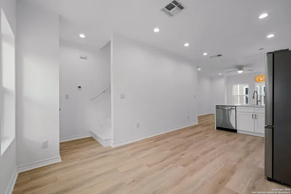 a view of a kitchen with a sink and a refrigerator