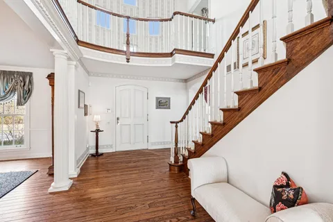 a view of entryway and hall with wooden floor