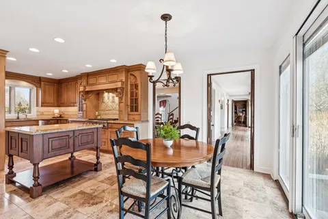 a view of an entryway with wooden floor leading to a furnished livingroom and windows