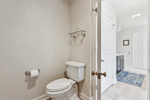 a view of a hallway with white walls and stairs