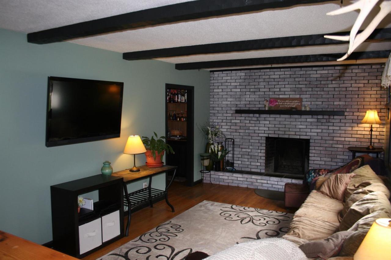 35 Chatham Lane Mashpee, MA 02649 - Photo 1 of 16 a living room with furniture a flat screen tv and a fireplace