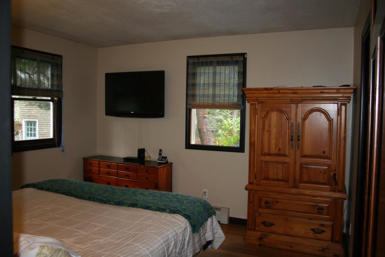 35 Chatham Lane Mashpee, MA 02649 - Photo 4 of 16 a bedroom with a bed and a flat tv screen on dresser