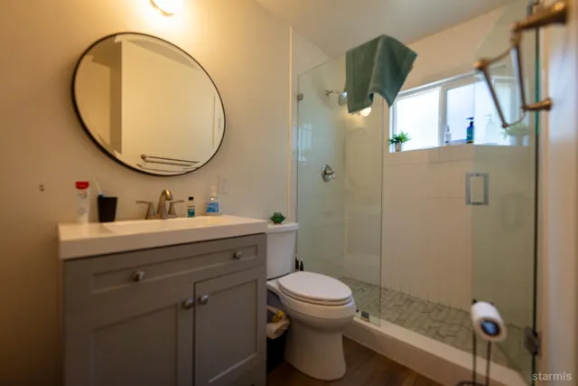 a bathroom with a sink a toilet and a mirror