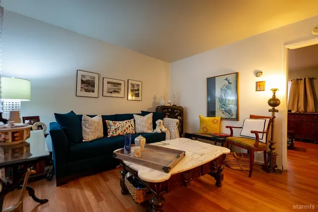 a living room with furniture and wooden floor