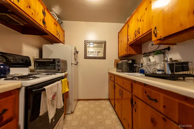 a kitchen with stainless steel appliances granite countertop a stove and a sink
