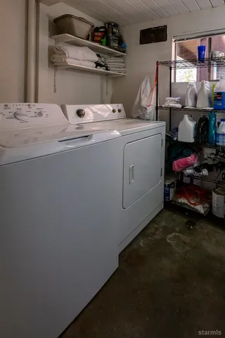 a room with a refrigerator and a wooden floor