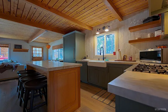 a kitchen with sink stove and cabinets