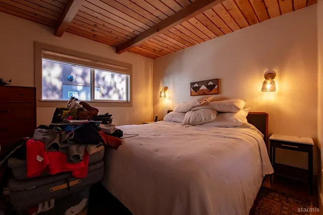 a bedroom with bed and window