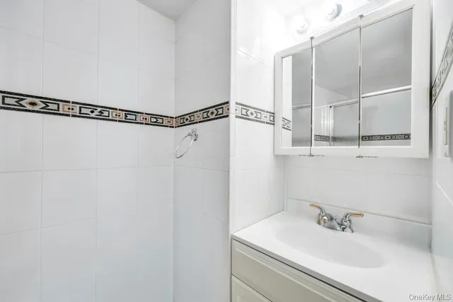 a bathroom with a glass shower door