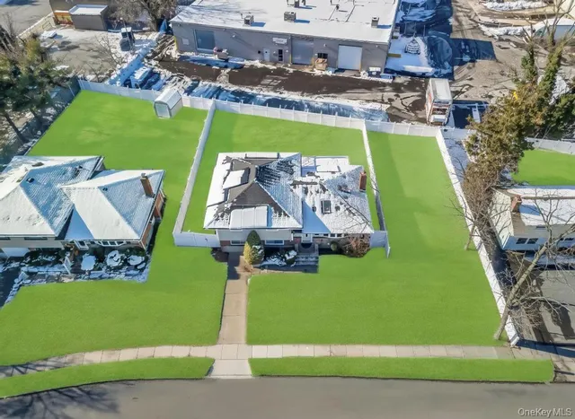 an aerial view of a house with a garden and swimming pool