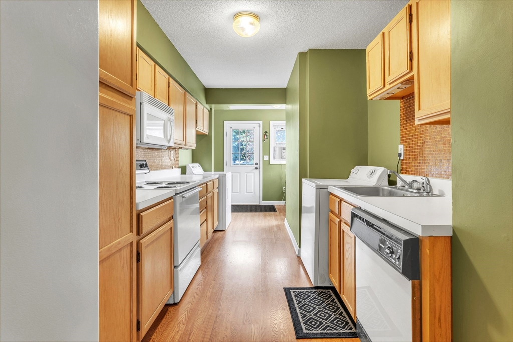 123 Outer Drive, Unit 123 Chicopee, MA 01022 - Photo 13 of 33 a kitchen with a sink stove and refrigerator