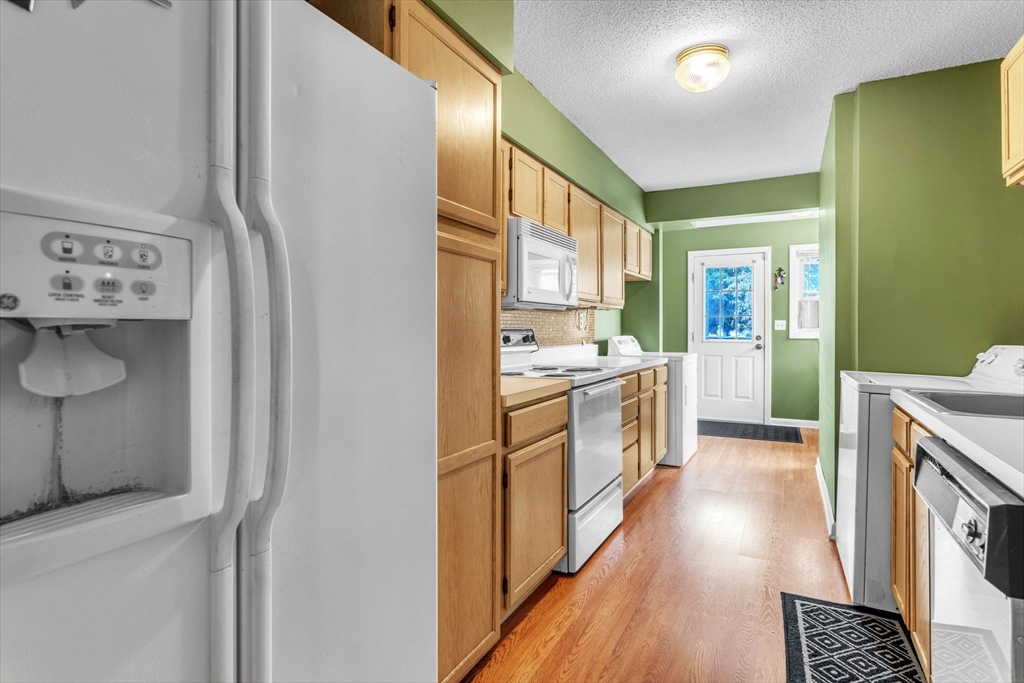 123 Outer Drive, Unit 123 Chicopee, MA 01022 - Photo 14 of 33 a large kitchen with a lot of counter space and wooden floor