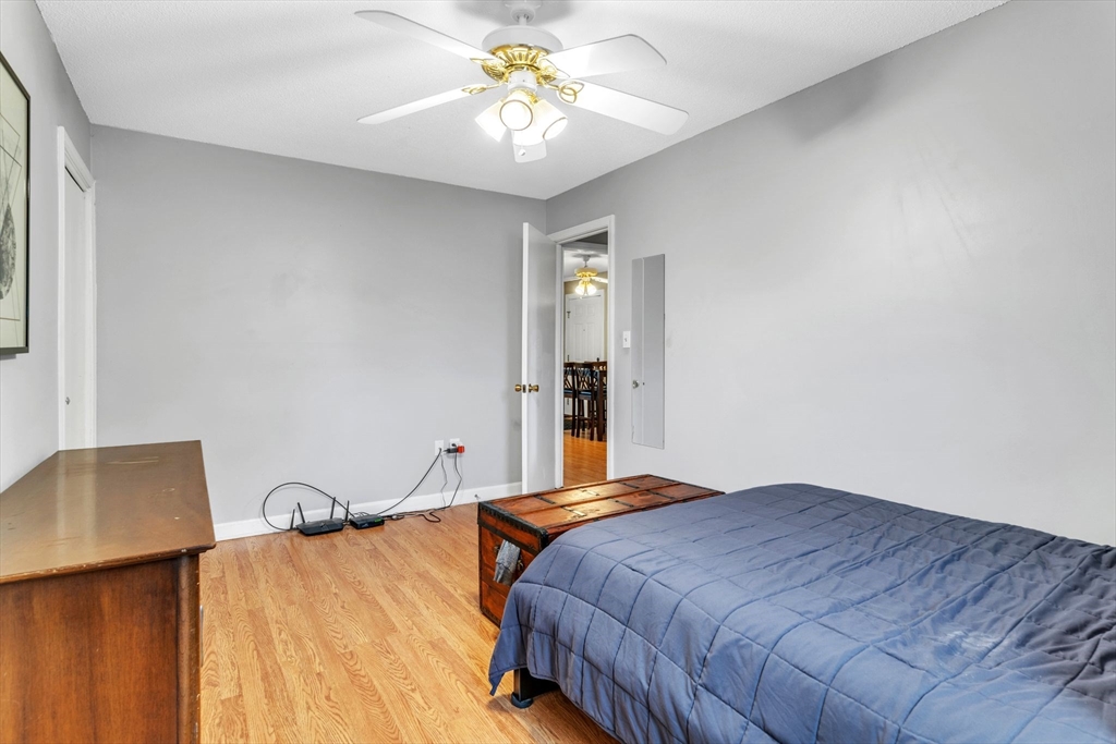 123 Outer Drive, Unit 123 Chicopee, MA 01022 - Photo 22 of 33 a bedroom with a bed and a chandelier