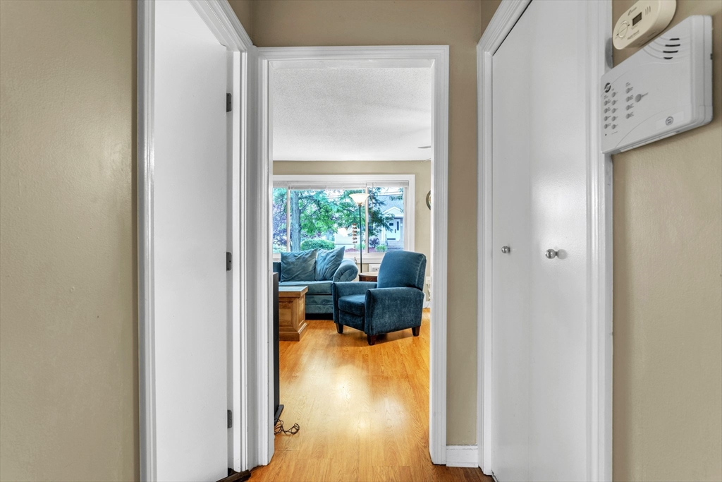 123 Outer Drive, Unit 123 Chicopee, MA 01022 - Photo 23 of 33 a hallway with a dining table and a potted plant next to a window