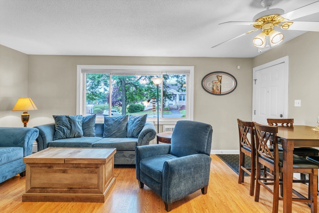 123 Outer Drive, Unit 123 Chicopee, MA 01022 - Photo 8 of 33 a living room with furniture a clock and a window