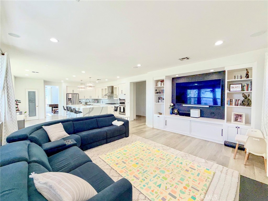 25714 Wallace Place Stevenson Ranch, CA 91381 - Photo 4 of 24 a living room with furniture and a view of kitchen