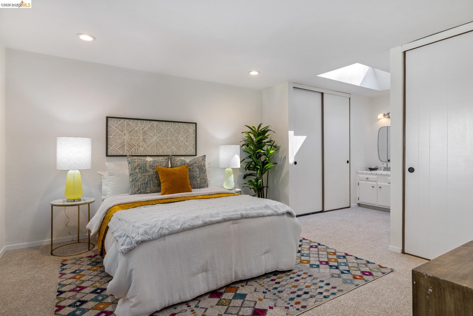 6660 Sobrante Road Oakland, CA 94611 - Photo 6 of 48 Recessed lighting, skylight, carpeted flooring, sliding closet doors, and a vanity with a mirror
