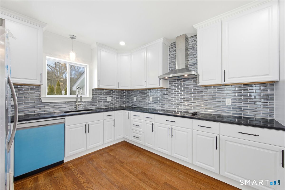 52 Coram Street Hamden, CT 06517 - Photo 16 of 40 a kitchen with granite countertop white cabinets and white stainless steel appliances