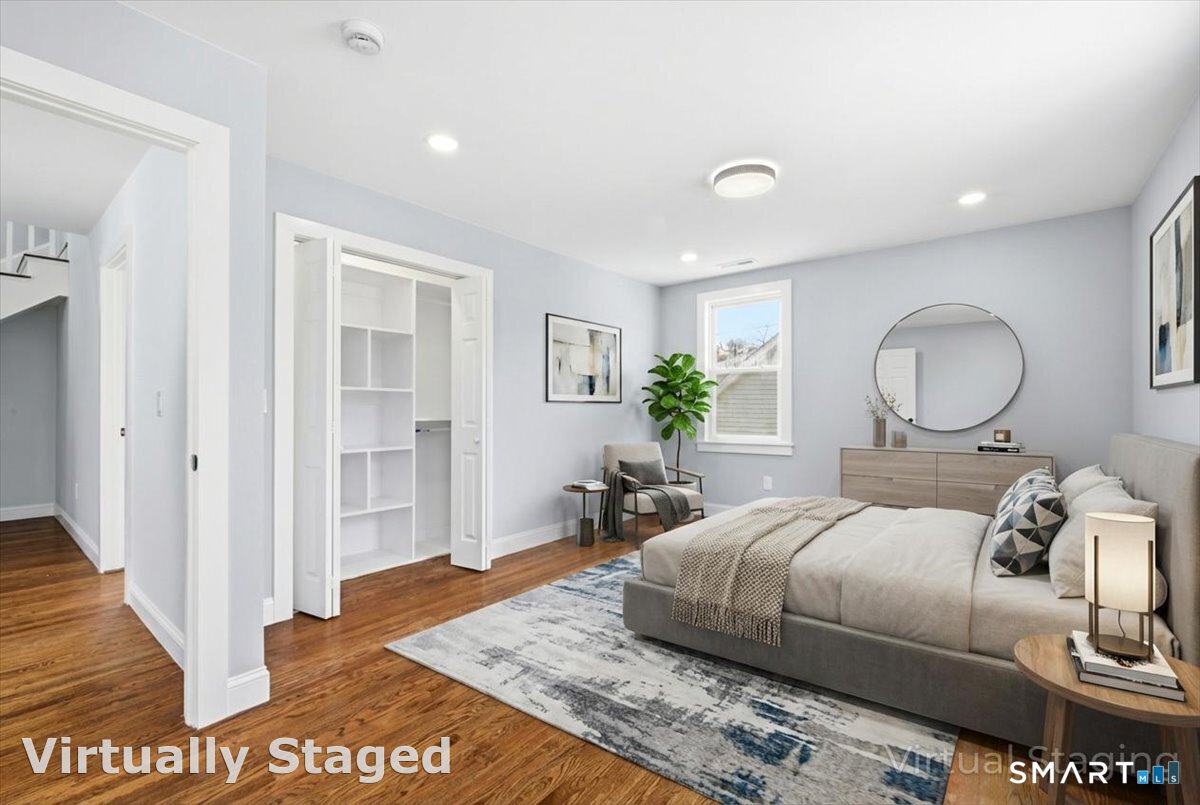 52 Coram Street Hamden, CT 06517 - Photo 29 of 40 a bedroom with a bed and wooden floor