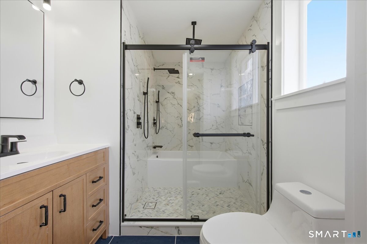 52 Coram Street Hamden, CT 06517 - Photo 30 of 40 a bathroom with a granite countertop sink toilet and shower