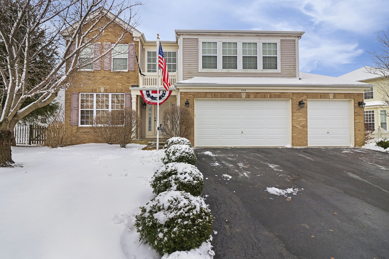 428 Cardinal Lane Bolingbrook, IL 60490 - Photo 1 of 36 a front view of a house with a yard and garage