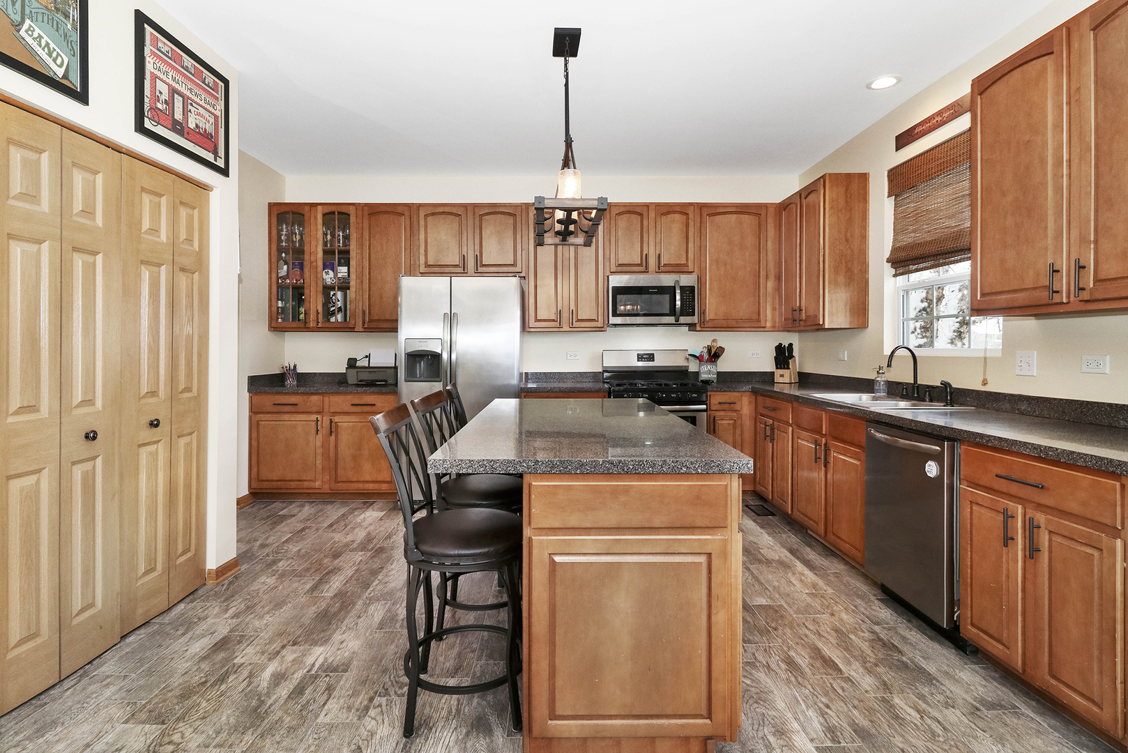 428 Cardinal Lane Bolingbrook, IL 60490 - Photo 14 of 36 a kitchen with stainless steel appliances granite countertop a stove top oven a sink dishwasher and a microwave oven on the wooden floor