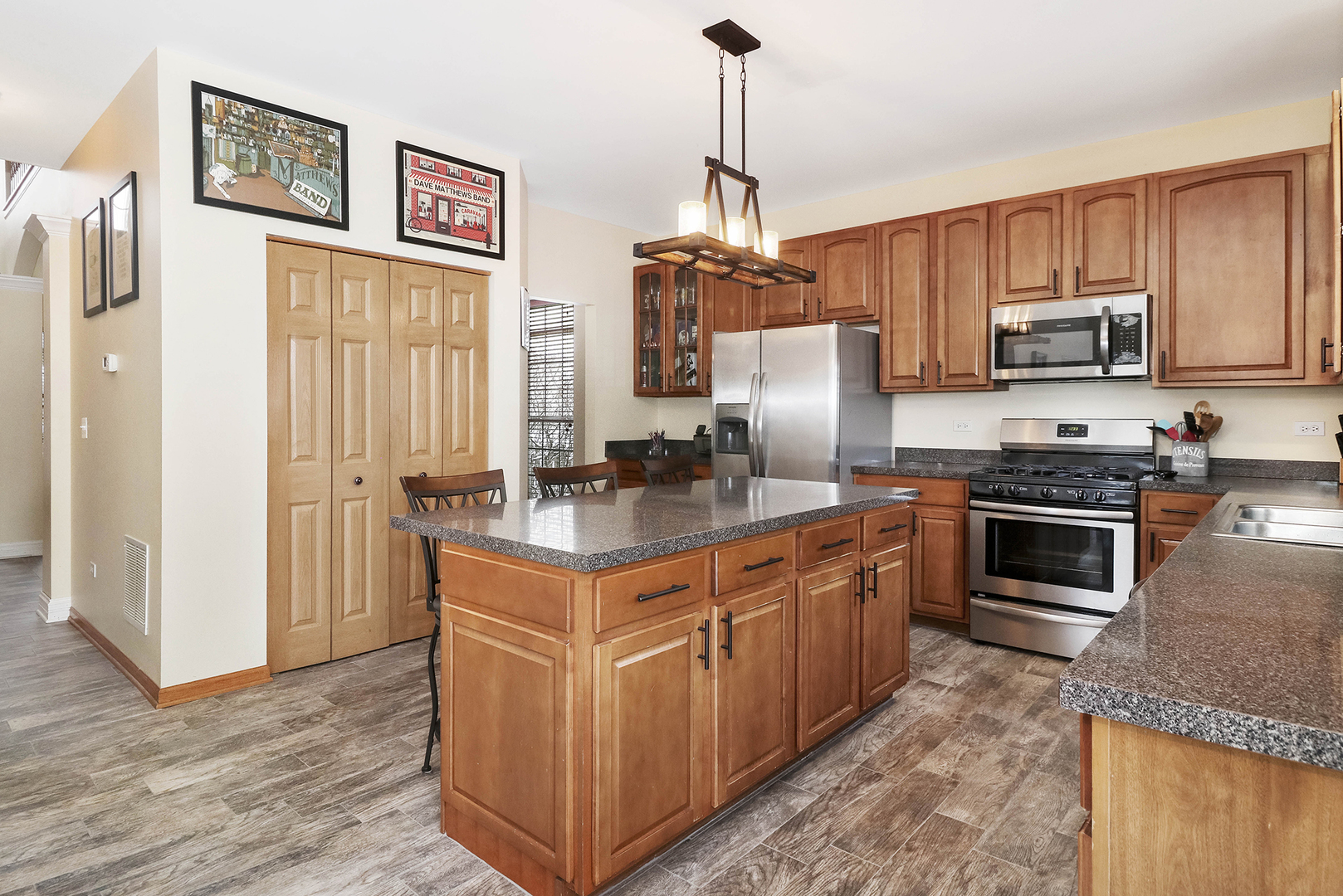 428 Cardinal Lane Bolingbrook, IL 60490 - Photo 15 of 36 a kitchen with stainless steel appliances granite countertop a stove top oven a sink and a refrigerator