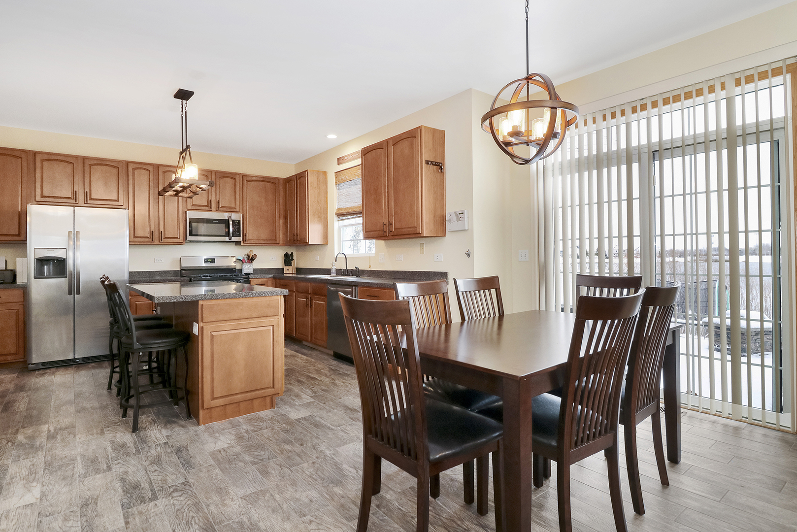 428 Cardinal Lane Bolingbrook, IL 60490 - Photo 17 of 36 a view of dining room and livingroom with furniture wooden floor a chandelier